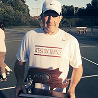 George Conlin poses with the Massachusetts Interscholastic Athletic Association sectional boys’ tennis tournament trophy won by his team.