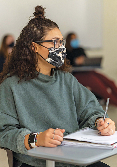 Students adhere to COVID-19 guidelines and wear masks while attending class