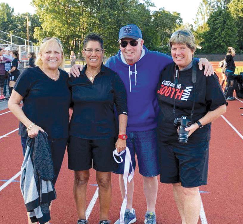 Cathy Meader, G’05, from left, Ann Simons, Deke Pillsbury (Simons’ West Springfield High School softball coach), and Springfield College field hockey and softball teammate Beth Gutteridge ’81