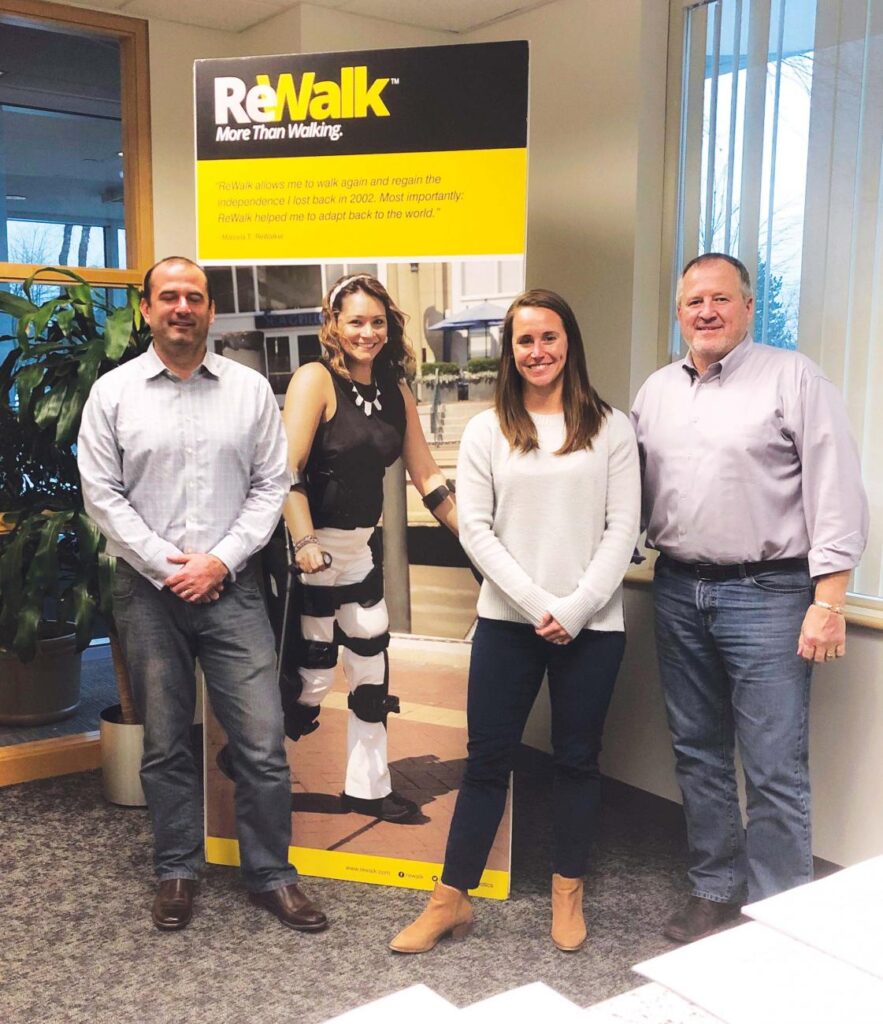 From left are Andy Dolan ’01, Lauren Peltier ’09, DPT ’11, and Loren Wass ’83, who work for ReWalk Robotics, a medical device company that is designing, developing, and commercializing exoskeletons, allowing wheelchair-bound individuals to stand and walk once again. Wass is vice president of sales and reimbursement, North America; Dolan is vice president, worldwide marketing; and Peltier is the business development manager. The company is based in Marlborough, Mass., and Yoknam, Israel.