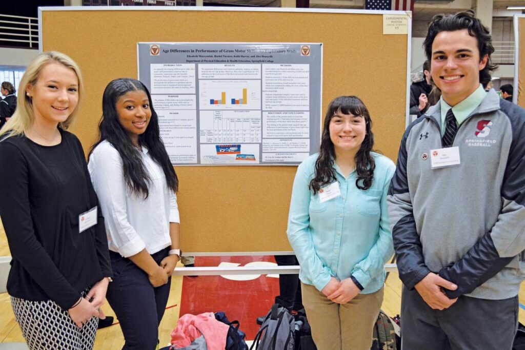 Students present posters during the Scholars in Action Day.