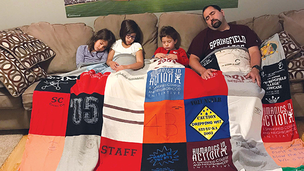 Josh Urrutia ’05 and his children rest after Sti-yu-ka Games push-up competition.