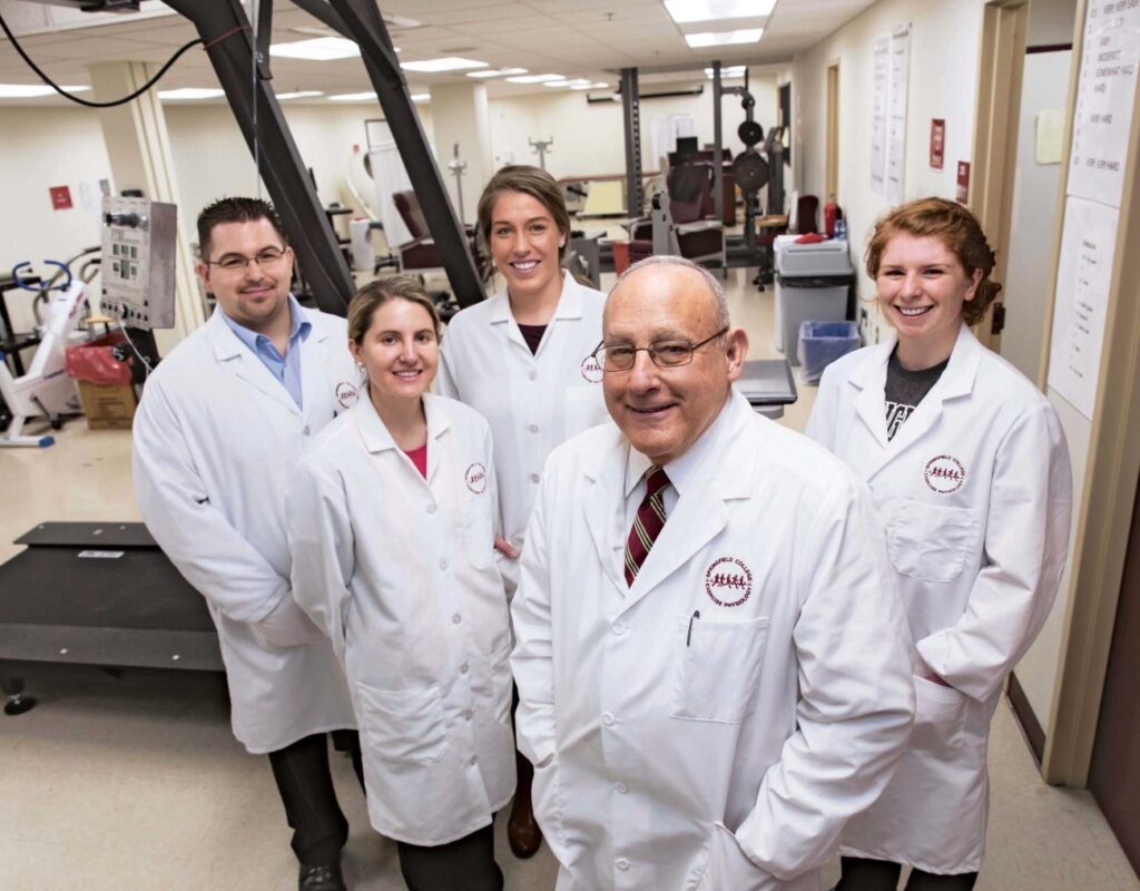 Vince Paolone, foreground, with former students, including Jessica Peacock, PhD'17, center