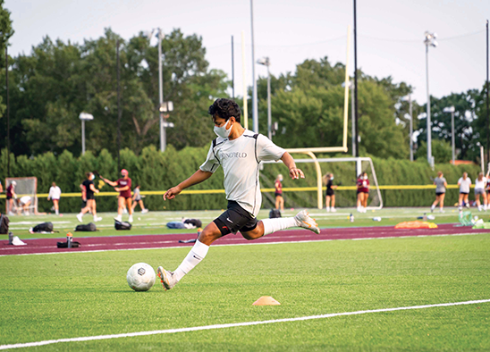 male soccer player kicking the ball