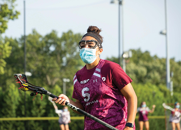 masked female lacrosse player