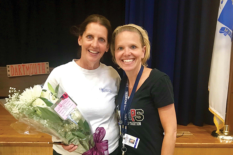 Mary Robertson is surprised with a bouquet from the alumni association.