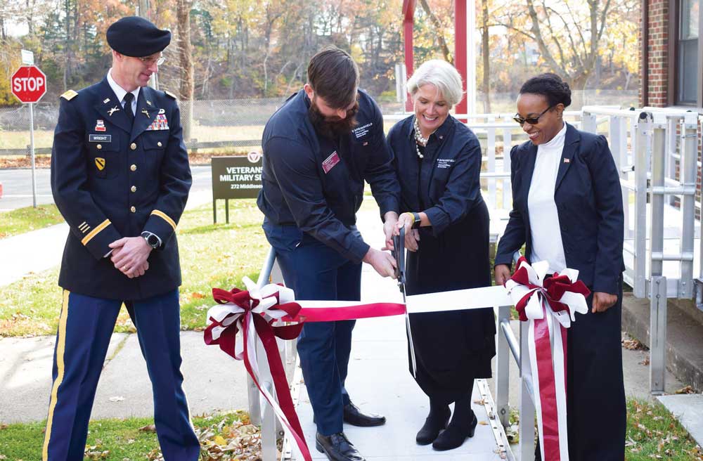 From left, Travis Wright, ARMY ROTC; graduate student Logan Large; President Mary-Beth Cooper; and Vice President for Student Affairs Slandie Dieujuste observe Veterans Day with a ribbon cutting for the Veterans and Military Services Center.