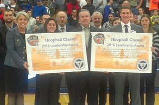 Springfield College President Mary-Beth Cooper, left, sport management major Emily Vance, Naismith Memorial Basketball Hall of Fame President and CEO John Doleva, and sport management major Eric Pouliot take part in the 2015 Hoophall Classic Leadership Award ceremony at Blake Arena.