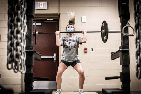 female athlete with barbell